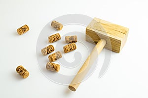 corks and the hammer for corking wine bottles on a white background