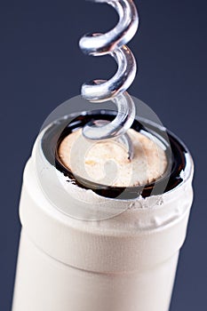 Corkscrew in cork in wine bottle