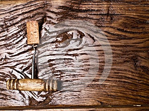 Corkscrew and corks on the wooden table.