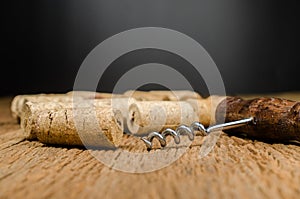 corkscrew for open wine bottle on wooden background