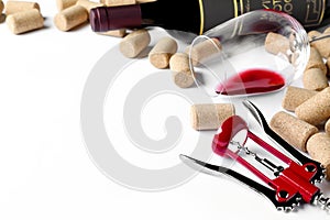 Corkscrew with wine bottle, glass and stoppers on white background