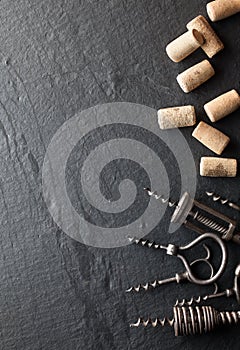 Corkscrews and corks on a dark background