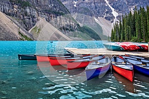 Corlorful canoes on Moraine lake near Lake Louise village in Banff National Park, Alberta, Rocky Mountains Canada