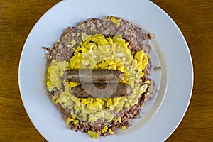 Corn beef hash top with scrambled eggs and sausage