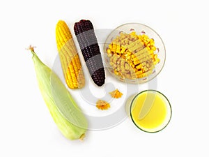 Corn, boiled yellow and purple corn, corn sliced in a cup, milk in glass and fresh corn on the cob