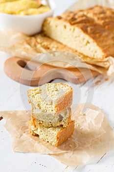 Corn bread cut in peaces on white wood background