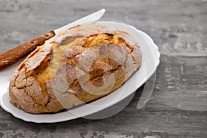Corn bread with knife on white dish