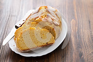 Corn bread with knife on white dish