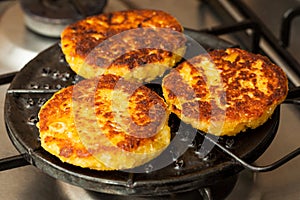 Corn breads being roasted on a round grill