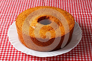 corn cake on white plate on rustic wooden table. Typical Brazilian party food