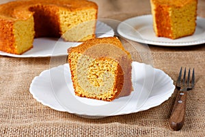 corn cake on white plate on rustic wooden table. Typical Brazilian party food