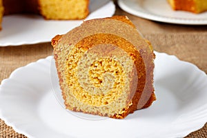 corn cake on white plate on rustic wooden table. Typical Brazilian party food