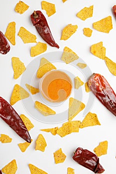 corn chips nachos with sauce and chili isolated on white background