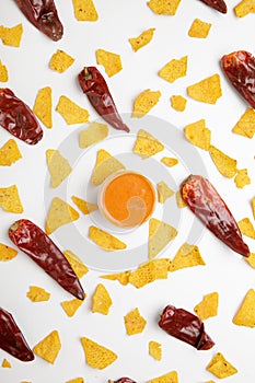 corn chips nachos with sauce and chili isolated on white background