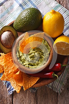 Corn chips, sauce guacamole and ingredients closeup. vertical