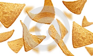 Corn chips of triangular shape levitate on a white background