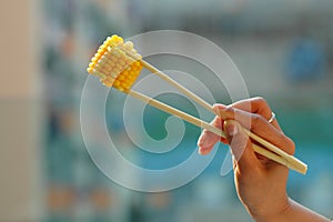 Corn on chopsticks photo