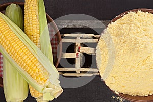 Corn cobs and corn flour on old weight scale.