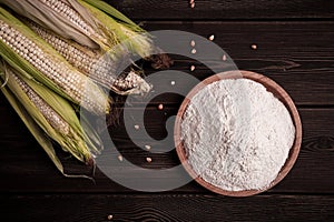 Corn cobs, corn flour, on a wooden table, top view, close-up, rustic, selective focus, dairy corn,