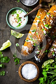 Corn cobs grilled, served with beer,salt, coriander and lime