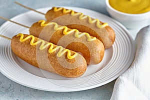 Corn dog traditional American corndog junk food fried hotdog sausage snack with mustard