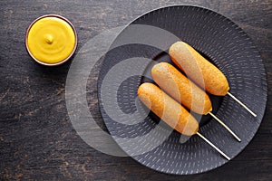 Corn dog traditional American corndog street junk food deep fried hotdog meat sausage snack treat on stick