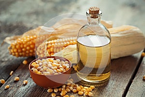 Corn essential oil bottle, seeds in bowl and corncobs