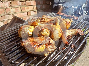 Corn fed chicken thighs and drumsticks with outdoor pork belly prepared on a charcoal grill