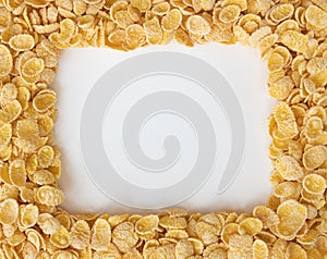 Corn flakes background, frame of cornflakes on white