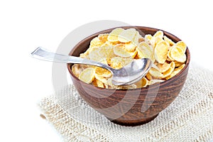 Corn flakes in a bowl of ceramic and spoon.