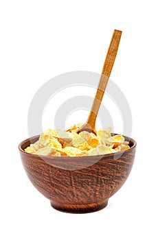 Corn flakes in a bowl of ceramic and wooden spoon.