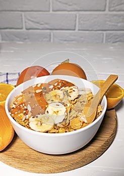 Corn Flakes Bowl with Milk, Persimmon, Orange on Wooden board on white background, Healthy Breakfast