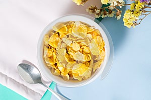 Corn flakes in a bowl with spoon for eating