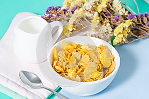 Corn flakes in a bowl with spoon for eating