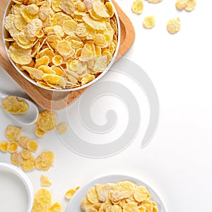 Corn flakes bowl sweeties with milk and orange on white background