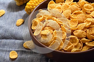 Corn flakes in a bowl on the table close-up, quick breakfast