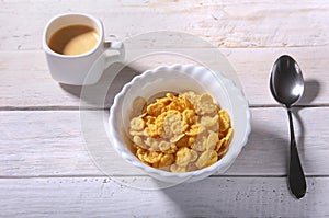 Corn Flakes cereal in a bowl and cap with espresso coffee. Morning breakfast.