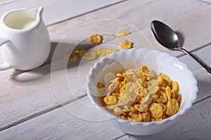 Corn Flakes cereal in a bowl and glass with milk. Morning breakfast.