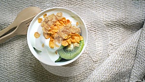 Corn flakes, cereal and milk splash in bowl. Natural homemade plain organic yogurt