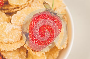 Corn flakes with fresh strawberry/corn flakes with fresh strawberry closeup. Top view