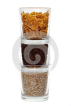 Corn flakes, sultanas and oatmeal in glasses
