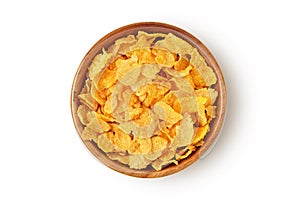 Corn flakes in wooden bowl on white background photo