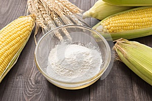 Corn flour and corn on wooden table