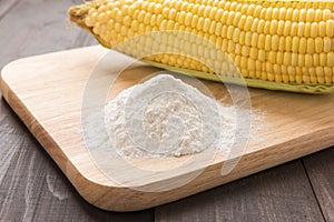 Corn flour and corn on wooden table