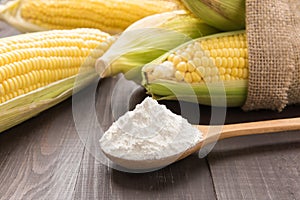 Corn flour and corn on wooden table