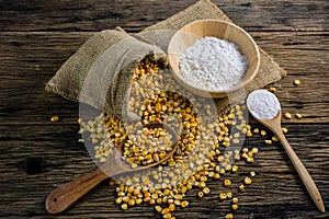 Corn flour and dried corn on a wooden table old.