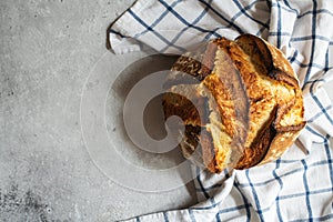 Corn flour sourdough bread on a napkin on a gray background. Copy space