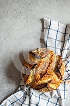 Corn flour sourdough bread on a napkin on a gray background. Copy space, top view