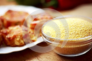 Corn flour on a wooden table in a bowl