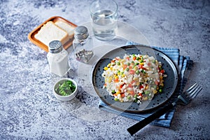 Corn green peas red pepper rice in a plate